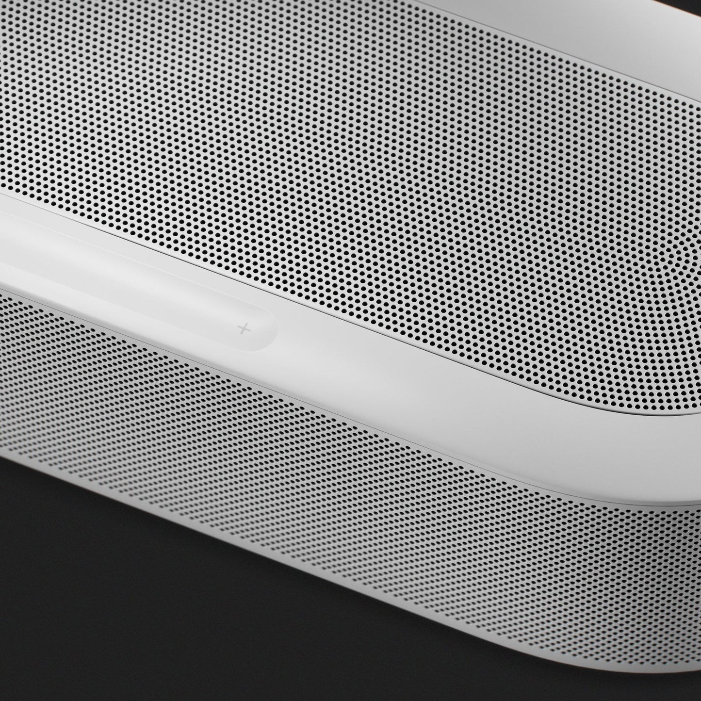 Sonos Beam Ultra in white, angled detail of the speaker grille